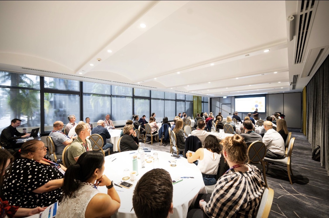 Professionals attending a facilitated workshop in a modern conference room